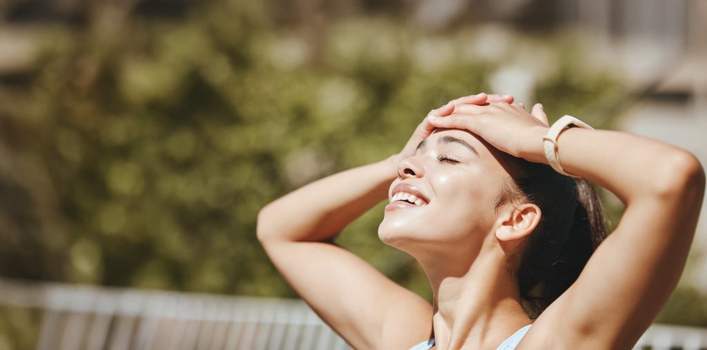Nature, relax and woman in sun happy with outdoor leisure and peaceful break for mental wellness. Stress free latino girl with relaxed, optimistic and positive smile enjoying sunshine rest.