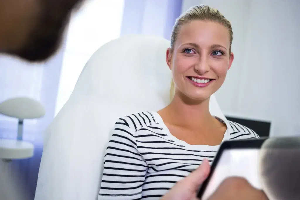 Female Patient Smiling While Looking Doctor