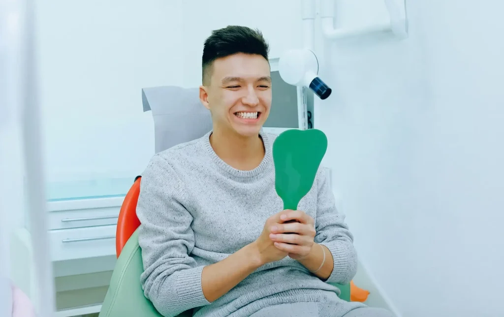 Portrait Of A Happy Patient In Dentist Chair